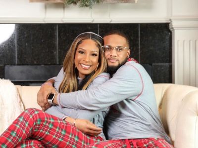 Jaylin Grant is hugging his mom, Kimmi Grant as they are posing for the picture on the couch.